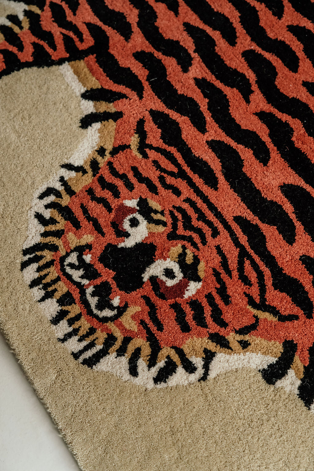 A hand-tufted Tibetan Tiger wool rug displayed in a room