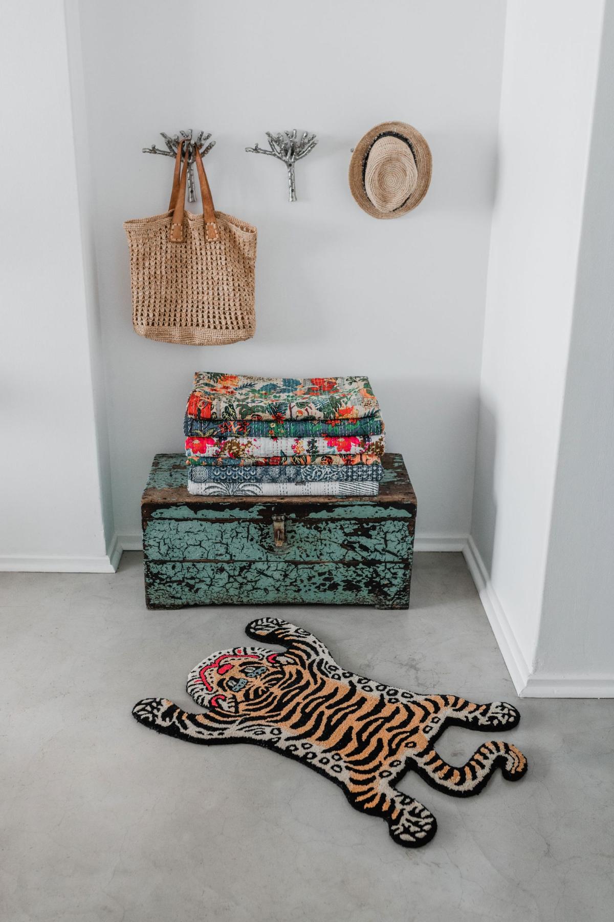 A tibetan tiger shaped rug on a floor in a bedroom in south africa