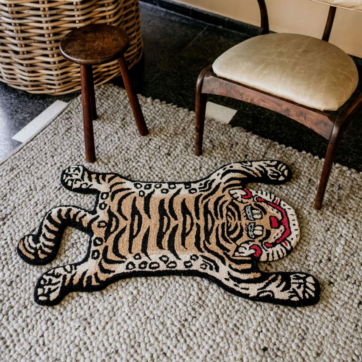 mini tibetan tiger style wool rug laying on a jute carpet. south africa