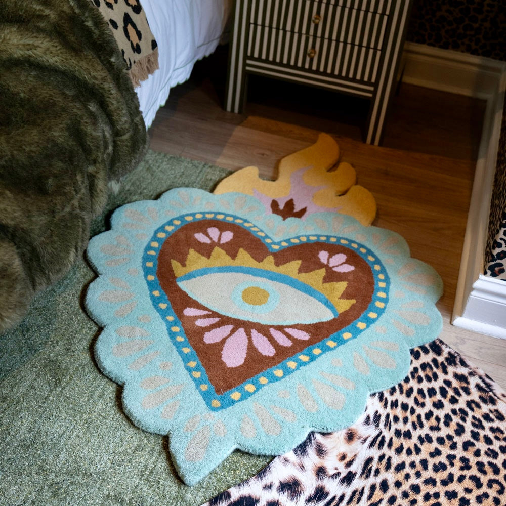 hand-tufted sacred heart wool statement rug with scalloped edges.