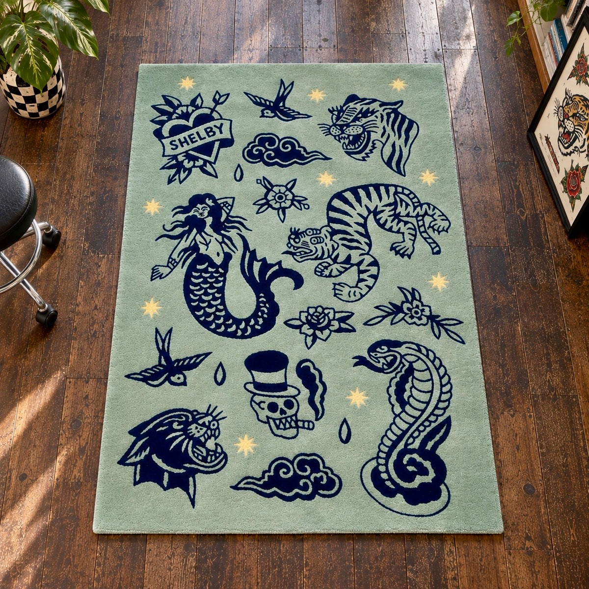 Hand tufted sage green flash tattoo wool rug with blue and yellow detailing