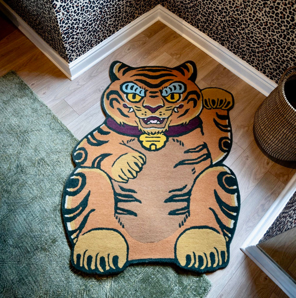 A large tiger-shaped area rug in orange, black, and yellow with blue eyes in south africa