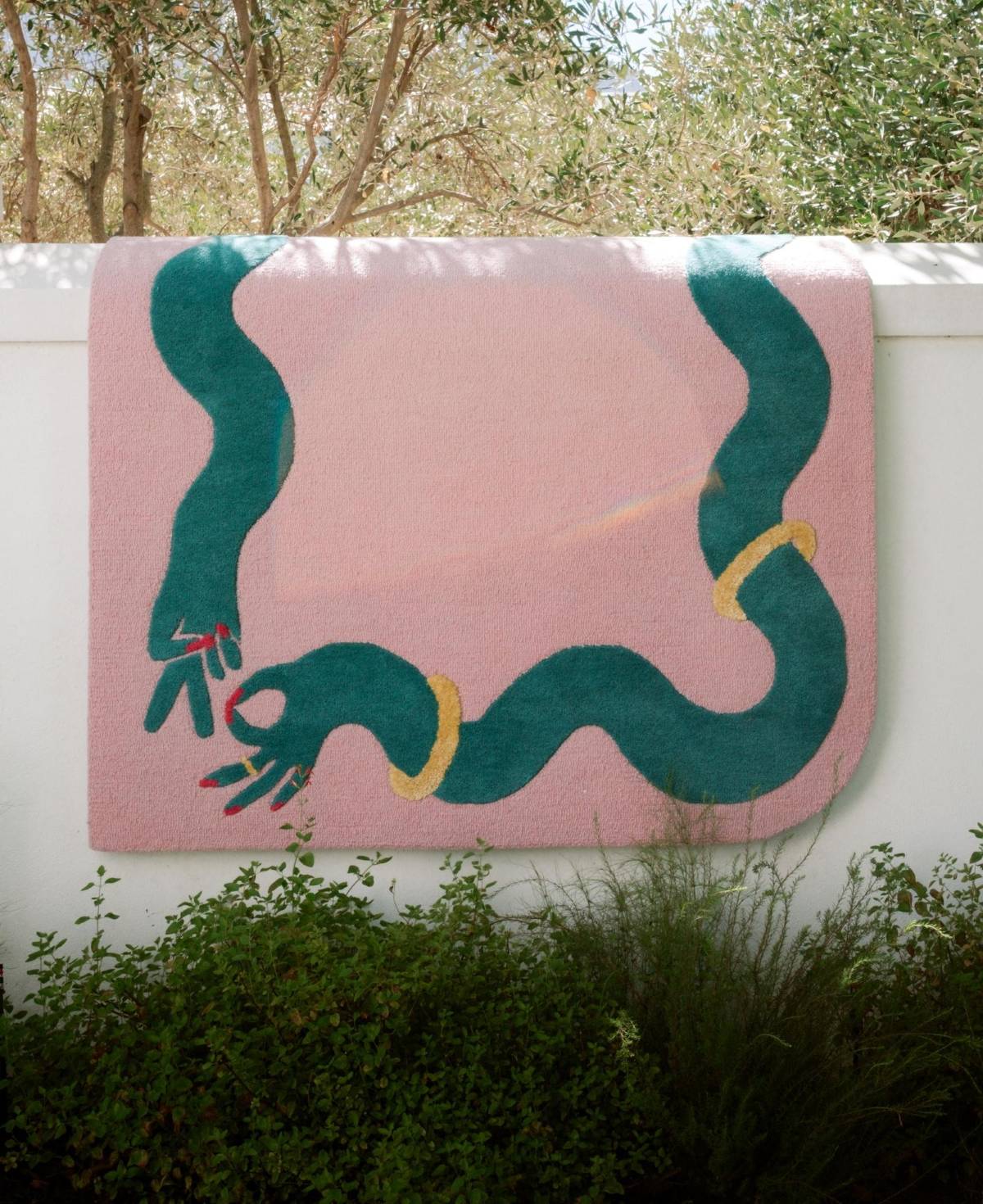 large pink wool statement rug with wavy green design