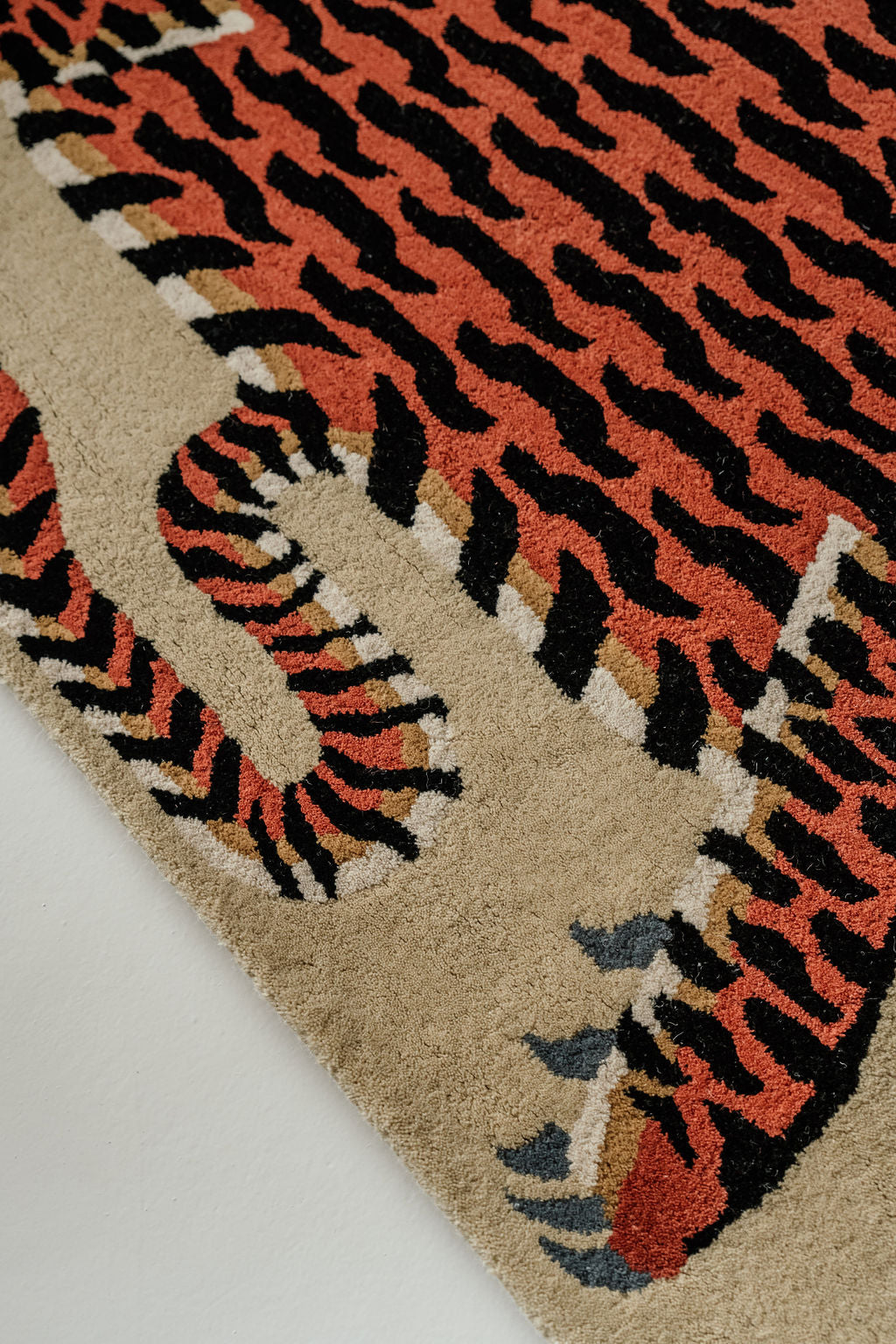 A hand-tufted Tibetan Tiger wool rug displayed in a room