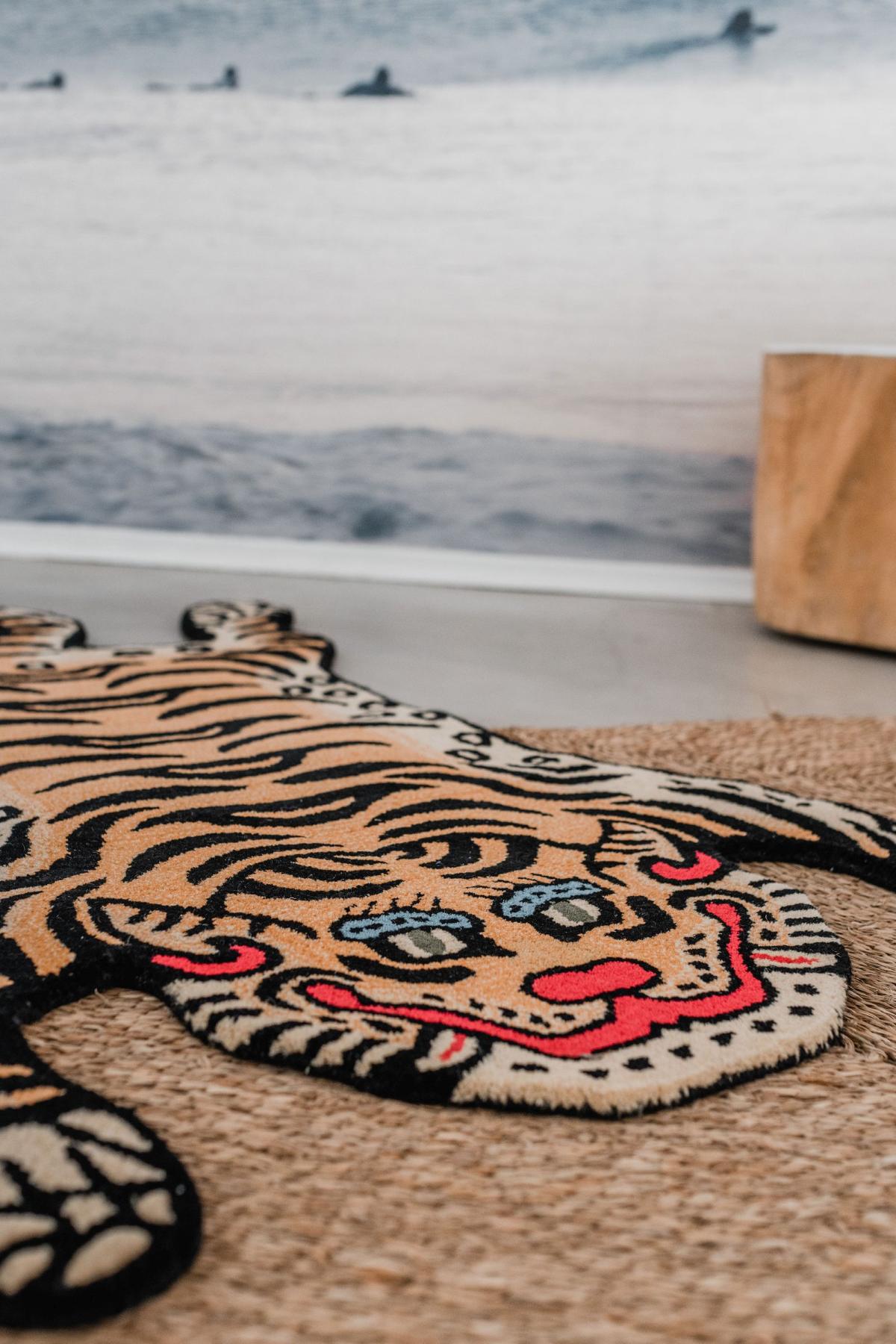 Tiger-shaped wool rug on a wooden floor in a kids bedroom