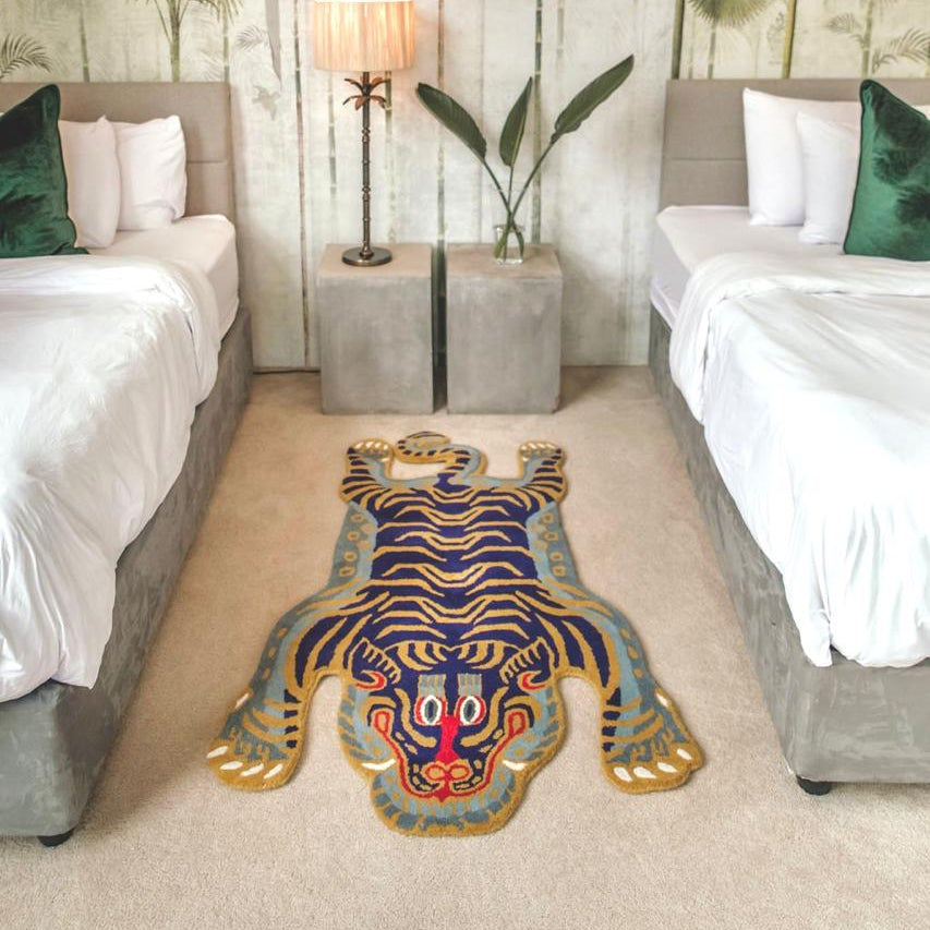 Limited edition Violet and gold wool tibetan tiger rug in a bedroom setting in south africa