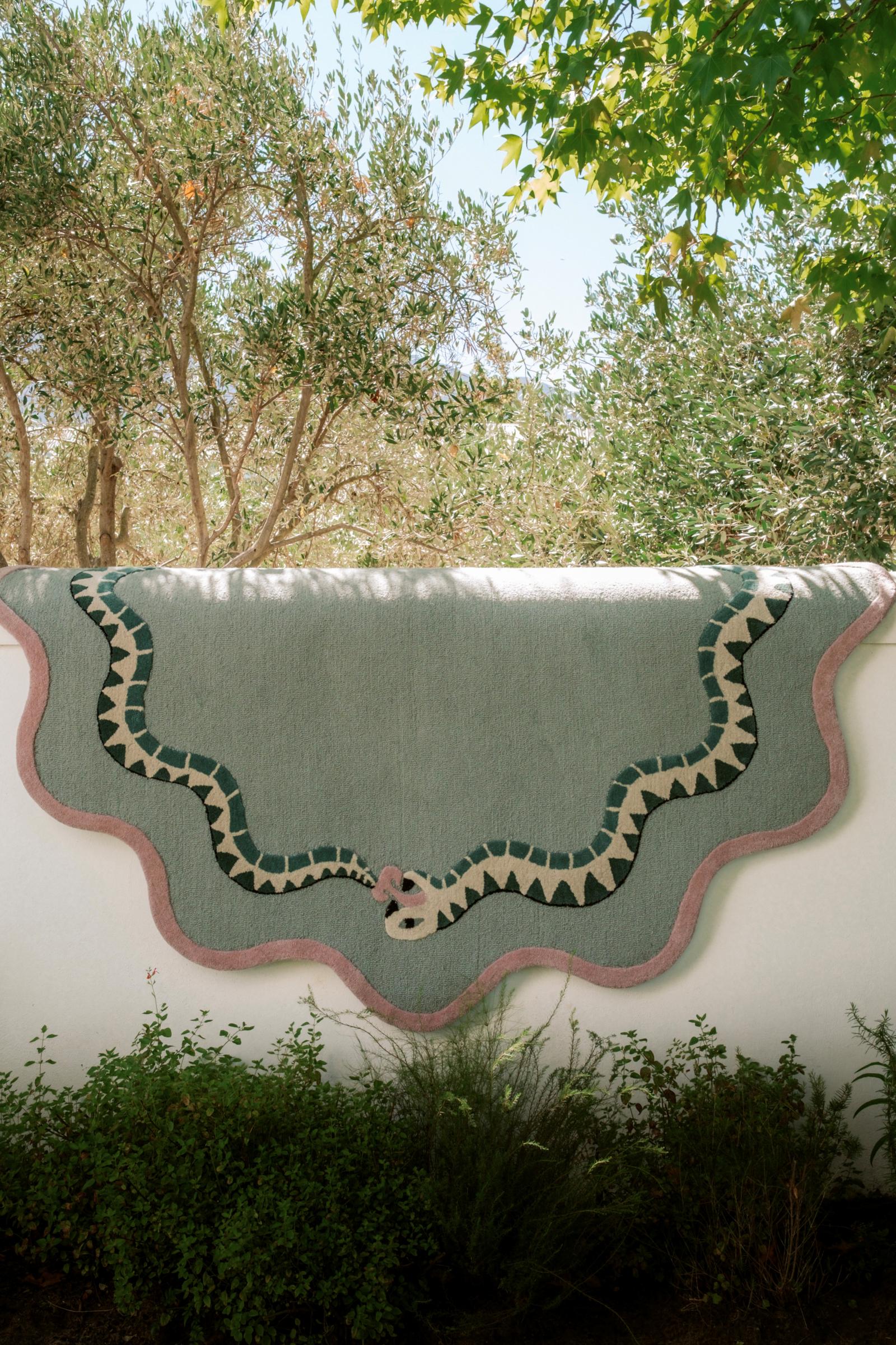 green snake wool rug displayed on a wall, statement rug south africa